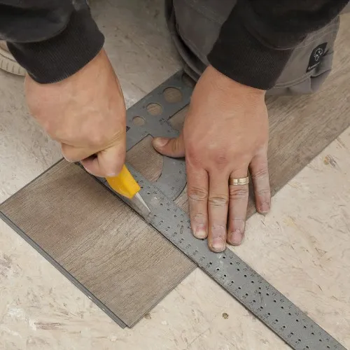 Worker installing vinyl flooring | Shans Carpets And Fine Flooring