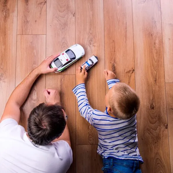 Dad and baby playing with toy cars | Shans Carpets And Fine Flooring