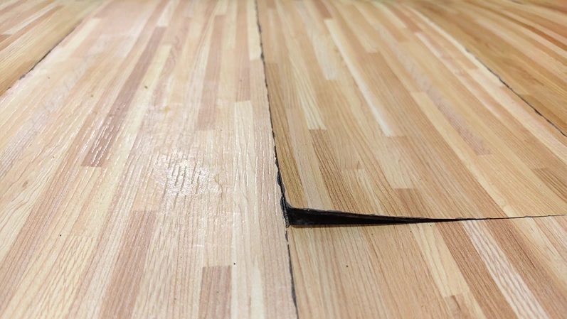 Damaged vinyl floor peeling from the surface.