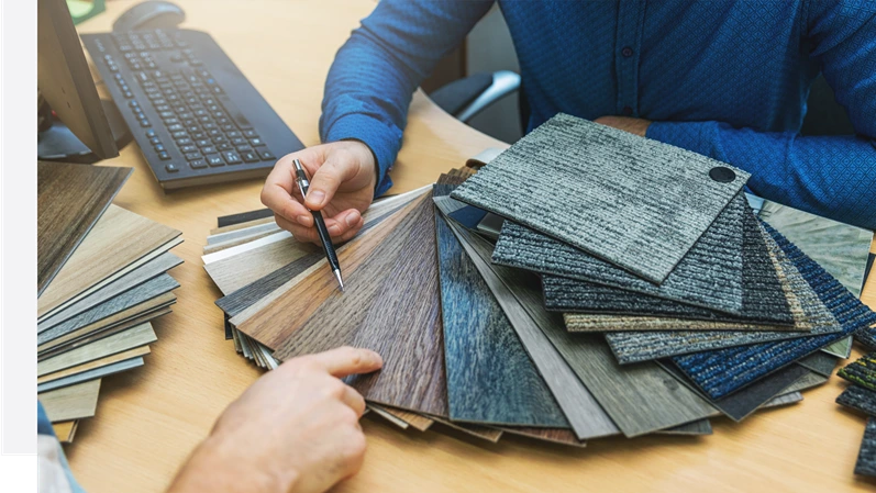 interior design - customer choosing floor material from samples at flooring shop