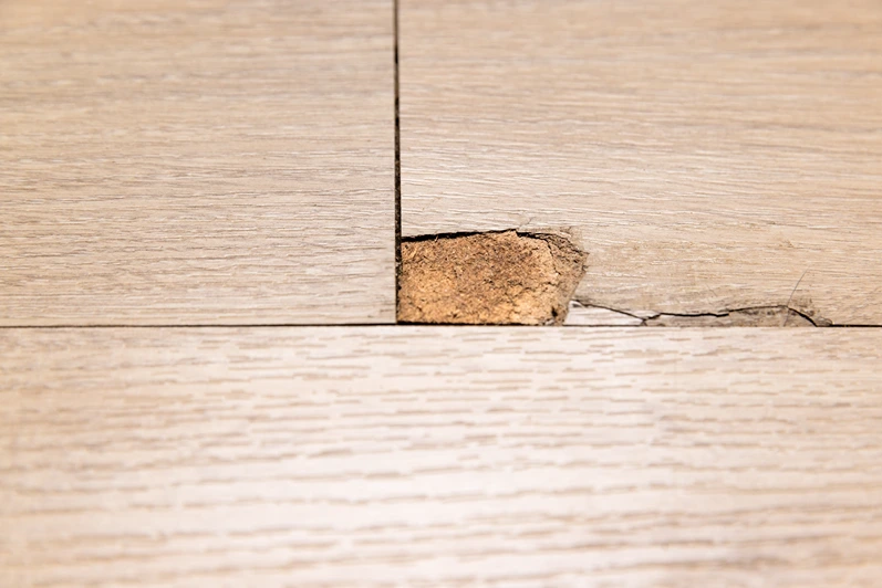 The Interlocking laminate floor is chip or crack due to scratches and impact. Repairing a damaged laminate floor concept.