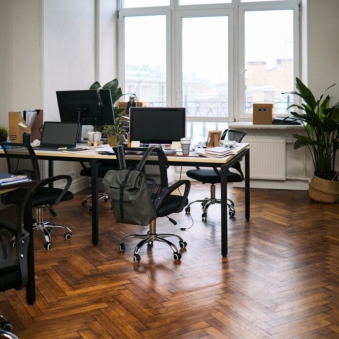 Empty,Modern,Office,Showing,Multiple,Workstations,With,Computer,Monitors,,Chairs,