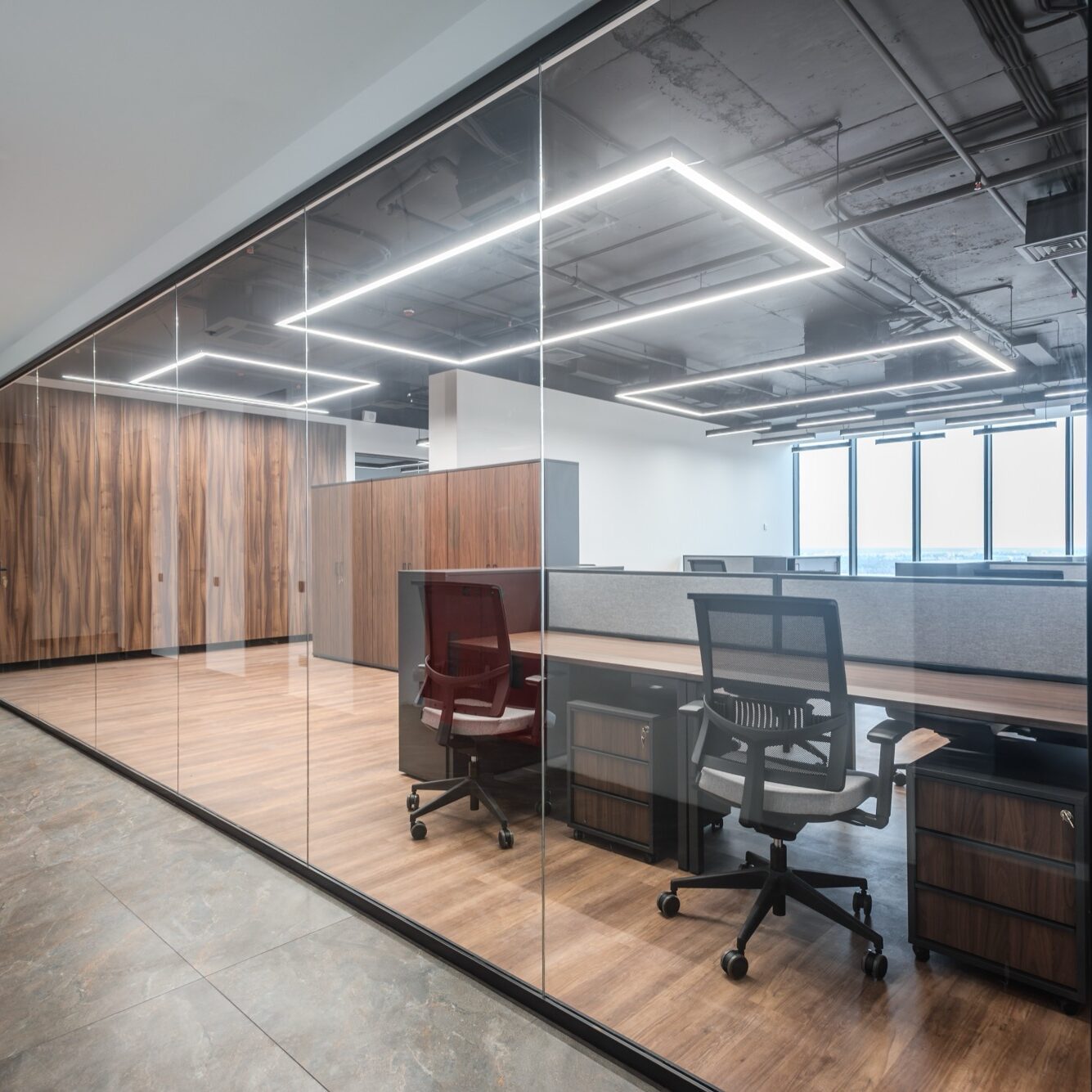 Business interior with office coworking zone and glass doors. Modern coworking space behind transparent glass wall, minimal interior